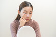 © KMPZZZ - Ophthalmology care, eyesight or vision. Asian young woman, girl hand holding and putting, wearing soft, daily disposable contact lens on her face with finger, looking into eye. Medical and health care