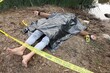 © New Africa - Forensic expertise. Crime scene with dead man's body, markers and police tape near lake outdoors