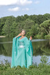 © Светлана  - Beautiful brunette girl in a turquoise long dress in nature by the lake. Siren