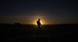© dedy - Soldier Silhouette Against Night Sky in War-Torn Landscape at Dusk
