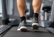 © Taufik - Man's legs on treadmill