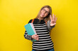 © luismolinero - Young student woman isolated on yellow background background happy and counting four with fingers