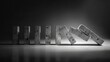 © Maraku - Concrete dominoes falling on dark background; risk, chain reaction concept
