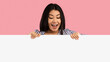 © Prostock-studio - Wow. Excited asian female standing behind white empty board for advertisement over pink background. Cheerful lady with open mouth looking down at big blank advertisement placard, empty space for text