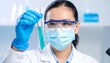 © Erlangga - Scientist Examining Green Liquid in Test Tube with Protective Gear