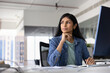© fizkes - Thoughtful successful young female Indian company worker in casual sitting at pc monitor at workplace, looking away, thinking on job task, creative idea for startup, planning strategy