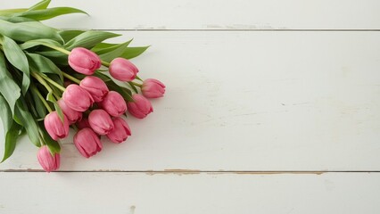 Wall Mural - bouquet of vibrant pink tulips displayed on a rustic white wooden surface with ample background spac
