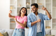 © Prostock-studio - Joyful hindu spouses dancing in living room interior at home, happy indian couple having fun and laughing, husband and wife enjoying spending time together