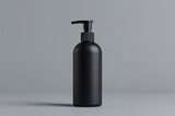 A sleek black bottle with pump dispenser on a gray background for cosmetic or hygiene products display