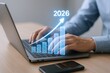 © The Little Hut - Business Growth Projection to 2026: Man Typing on Laptop with Rising Graph Overlay