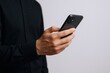 © The Little Hut - Man Using Smartphone: Business Professional Holding and Interacting with Mobile Device for Communication and Productivity