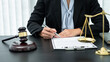 © Thitiphat - Female lawyer working with legal case document contract in office, law and justice, attorney, lawsuit concept