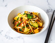 © antonihalim - Vibrant Asian noodle salad bursting with fresh vegetables and tofu