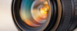 © Lubov - Close-up of camera lens with vibrant, blurred colorful background. Precision optics, aperture detail, modern photography technology visible. Macro shot of professional camera equipment, suitable for
