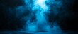 © Pixels Stock - A bright beam of ethereal blue light shines down through swirling mystical smoke and mist creating an atmospheric and dramatic effect on a dark background