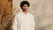 © Lubov - Young Indian man models traditional khadi shirt, promoting eco-friendly cultural attire. Natural fabric texture, subtle design highlights craftsmanship, heritage. Minimalist, authentic style conveys