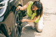 © milanmarkovic78 - Woman Replacing Flat Tire