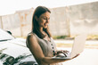 © milanmarkovic78 - Woman Using Laptop Beside Her Car
