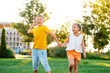 © Any Grant - little children flying a plane, a boy and a girl playing with a plane on a green lawn, laughing children on the grass in summer, summer holidays
