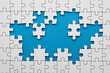© Pixel Studio - White jigsaw puzzle pieces on a blue background representing problem solving and teamwork concept