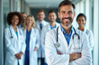 © Viktor - Diverse team of smiling doctors in white lab coats, standing together in a modern hospital hallway. Lead doctor with stethoscope, arms crossed, expresses confidence and expertise in healthcare.