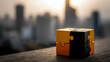 © Ashraf - Black and orange puzzle blocks on a blurred city background, representing the concept of business success