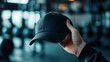 © Zainuddin - a sporty hand holding a cap during workout or training, gym background, active lifestyle branding.