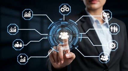 Woman Touching Holographic Interface with Blue Circular Design and Icons Overlays in a Dark Background Wearing a Black Blazer