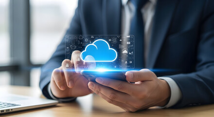 Businessman holding mobile device with illuminated cloud symbol, representing digital information and connectivity in modern business and data management.