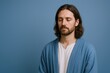 © The Little Hut - Man Meditating Against a Blue Background, Portrait of Serene Male with Closed Eyes, Contemplation and Inner Peace