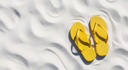 Yellow flip flop on white beach sand with wave pattern texture. Summer vacation and travel holiday concept design.