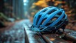 © photolas - A blue cycling helmet and gloves rest on a weathered wooden bench, hinting at an outdoor adventure waiting in a tranquil park surrounded by nature after rain.