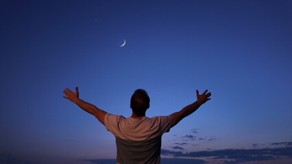 Wall Mural - man with arms wide open enjoying outdoors under stars, planets and moon.