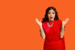 © Pixel-Shot - Beautiful shocked Indian woman in sari on orange background