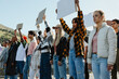 © Jacob Lund - Diverse group of activists holding blank signs at an outdoor rally