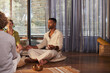 © Rido - African american man meditating in yoga class with copy space