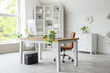 © Pixel-Shot - Interior of light office with modern workplace, shelf unit and green plants