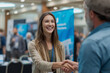 © Olga - Recruiter shaking hands with candidate, AI career fair banner in background.