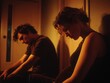 © Evgeniia - Exhausted couple in dim orange light, sitting apart with visible emotional tension, showing conflict and relationship struggle
