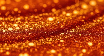 Golden glitter particles background with a warm orange bokeh effect and a shiny abstract texture