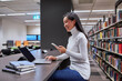 © Austockphoto - Young Asian student using laptop at university library