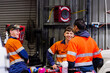 © Austockphoto - Three happy Australian men in industrial mechanics shed workplace chatting in conversation together