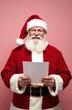 © chelmicky - Santa claus holding a blank letter mock up on pink background