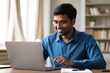 © Bhain - Man working from home on laptop, online meeting, remote work, home office, happy student
