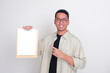 © KrishnaTedjo - Smiling Asian Man Wearing Glasses Pointing at Clipboard with Blank Paper