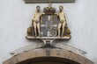 © Olaf Krüger/imageBROKER - Coat of arms with crown and two men, Stormgade 10, Copenhagen, Denmark