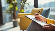 © Katerina - Person filling out therapy intake form with pen on clipboard in bright waiting room