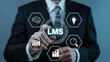 © SnapSpark Studios - Businessman interacting with a digital interface showing the learning management system lms concept with various business and education icons