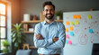 © Ruhel - Confident man with arms crossed in an office with a whiteboard and plants smiling