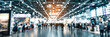 © Daniel - Blurred Trade fair show background, exhibition with booths for business, companies and industry to showcase and demonstrate products and services, for people, partners and customers